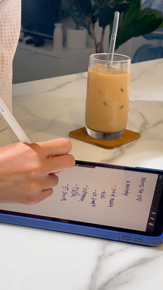 Hand Writing on an iPad with Juice on the Side